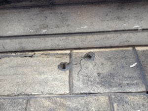 Bullet holes in the wall of Hotel de Dieu