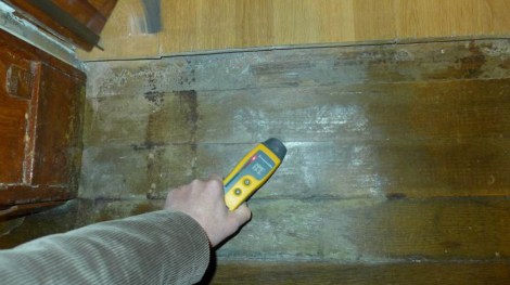 Court expert measures humidity levels of the water damage just outside my door. 