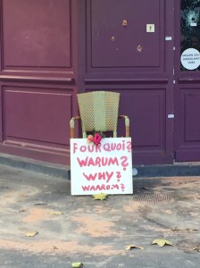 A touching tribute outside Cosa Nostra asks, "Why?" Bullet holes are still evident on the facade of the building. ©Lisa Anselmo