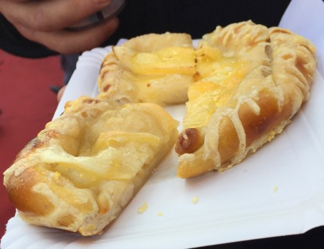 Cheese covered soft pretzel.