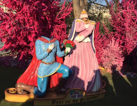 There is a little girl's head peeking out from this display, which says, 