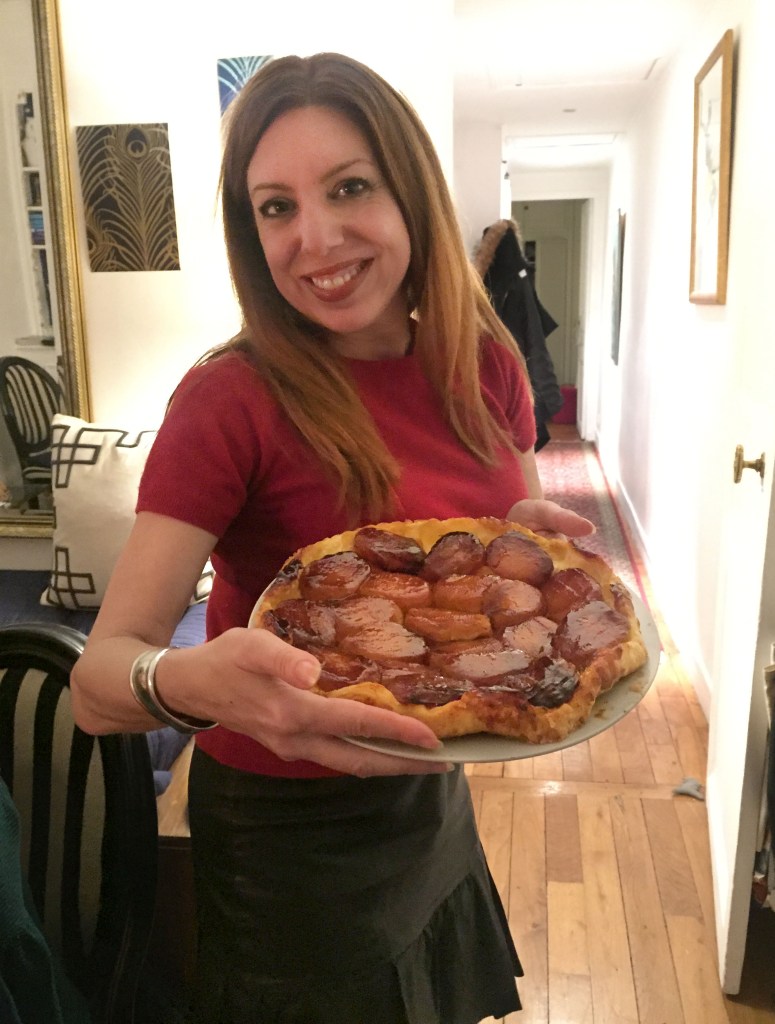Author Lisa Anselmo holding a tarte tatin, a traditional French apple pie.